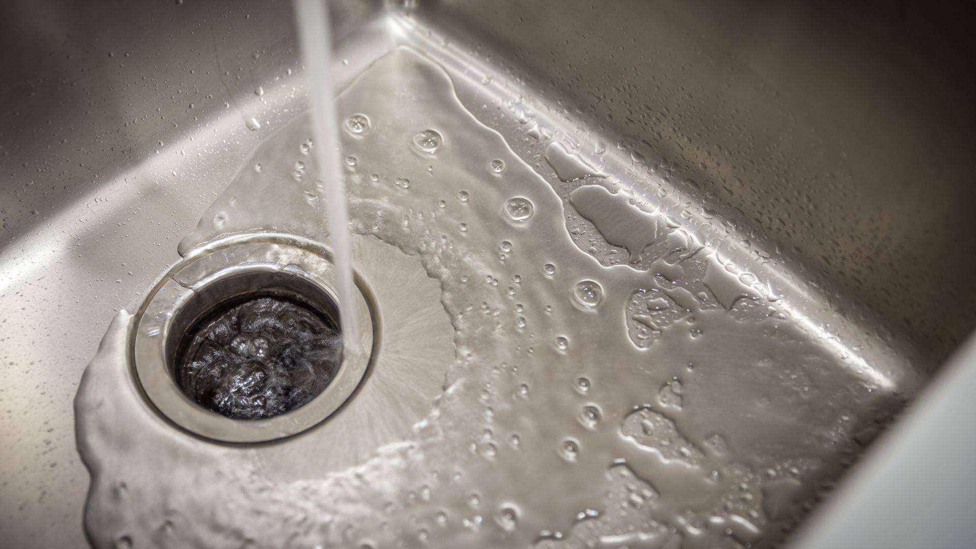 Image of a garbage disposal with water flowing through it