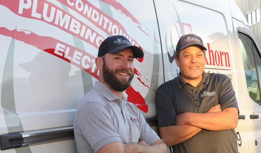 HVAC technician discussing maintenance with a homeowner