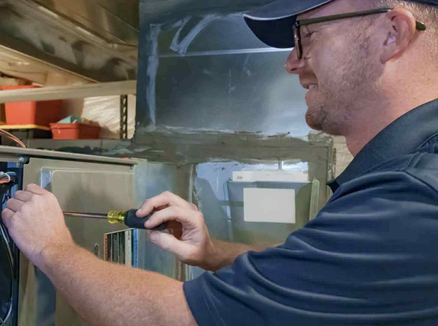 Image of an Elkhorn Heating & Air technician working on a furnace