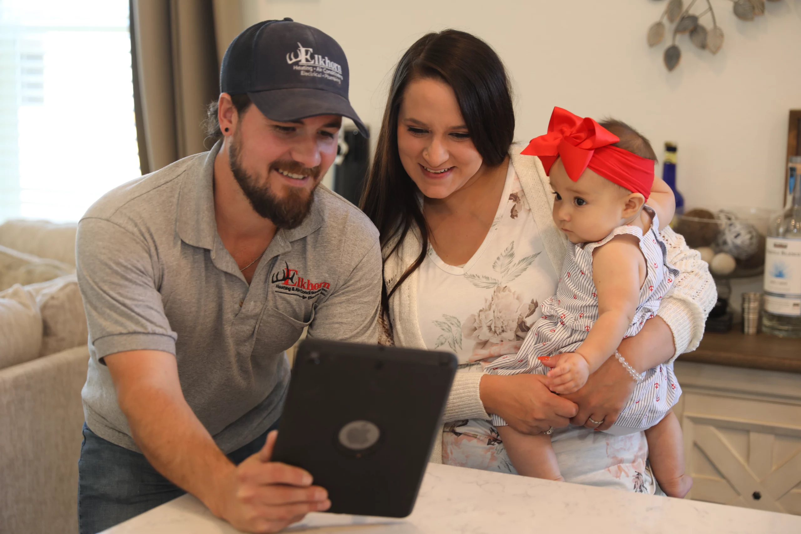 Elkhorn technician educating the homeowner about their HVAC equipment.