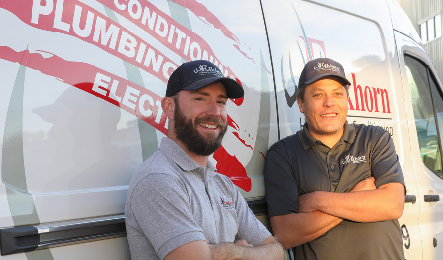HVAC technician discussing maintenance with a homeowner
