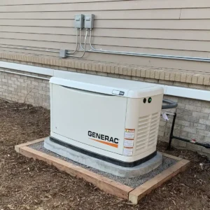 Newly installed residential Generac whole-home backup generator on a concrete pad next to a brick exterior wall with electrical conduit and disconnect switches at a Denver Colorado home, installed by Elkhorn Heating, Air Conditioning, Plumbing & Electrical
