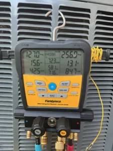 Denver AC repair technician servicing ducted cooling and starting up an evaporative cooler.