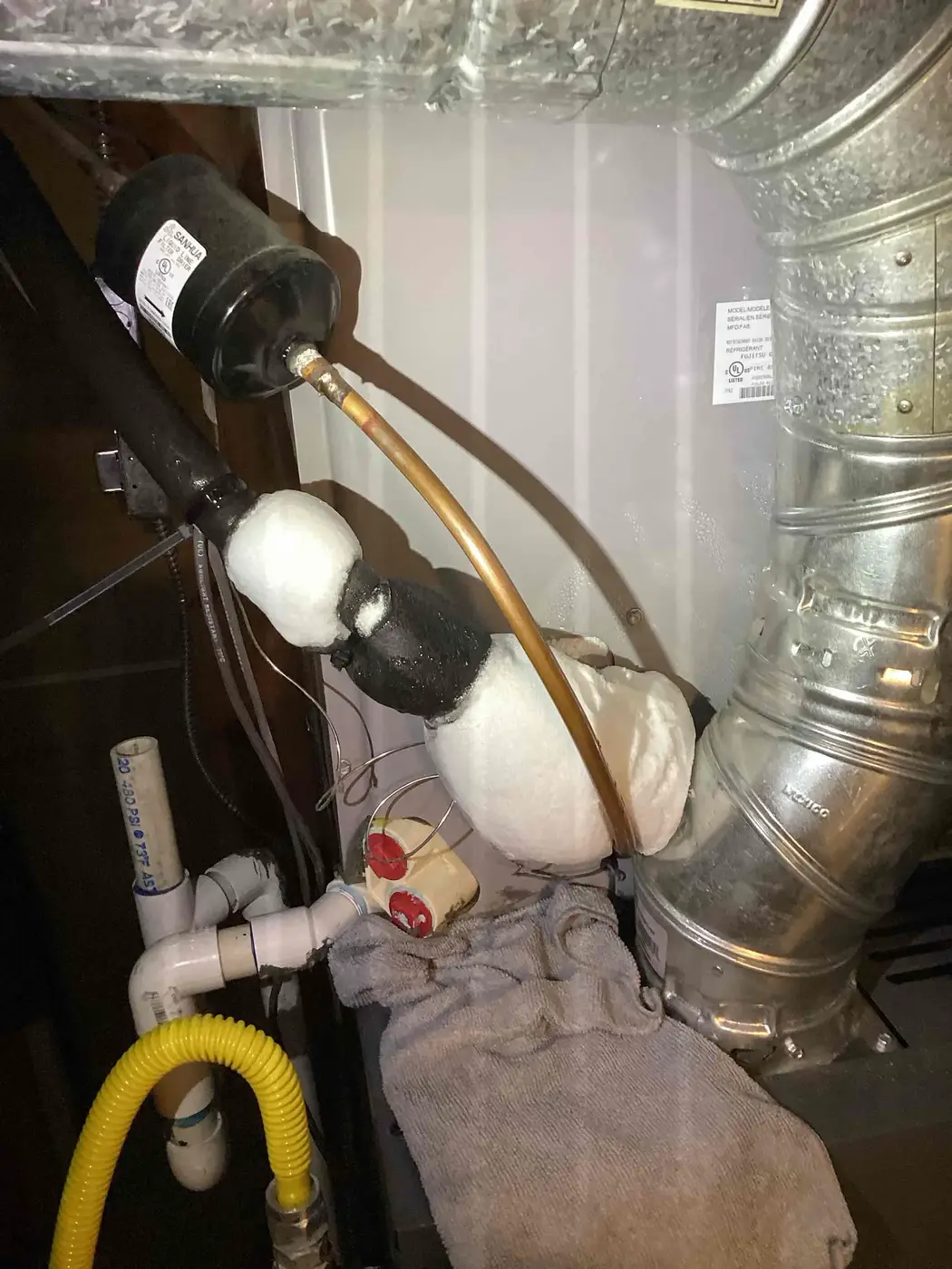 Ice buildup on a Denver HVAC refrigerant line during a frozen AC diagnostic.