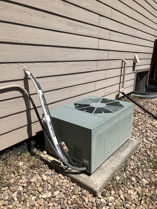 Outdoor air conditioning condenser at a Highlands Ranch home during an aging-system diagnostic.